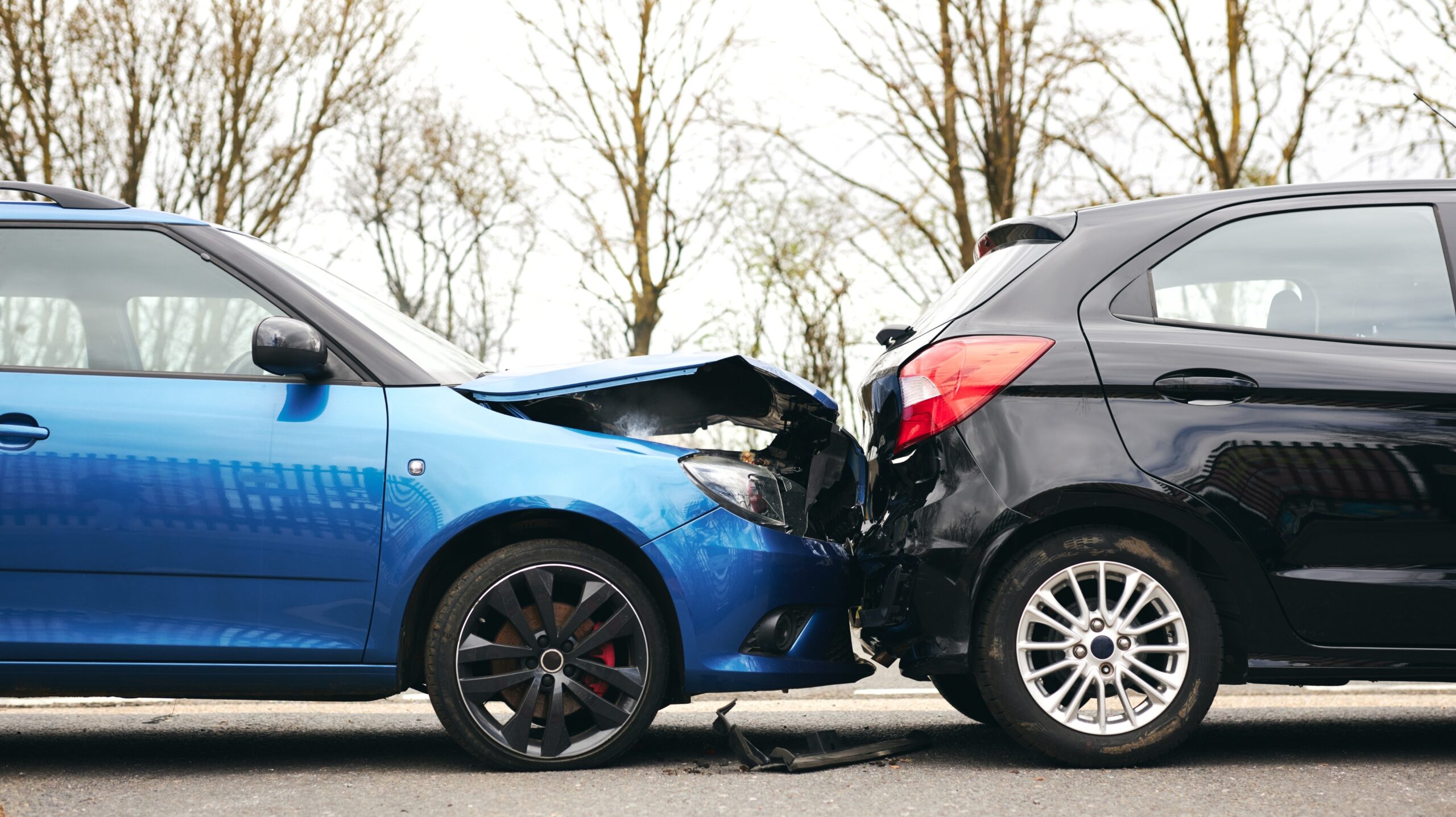 Car,Accident,Scene,With,A,Blue,Vehicle,Crashing,Into,A